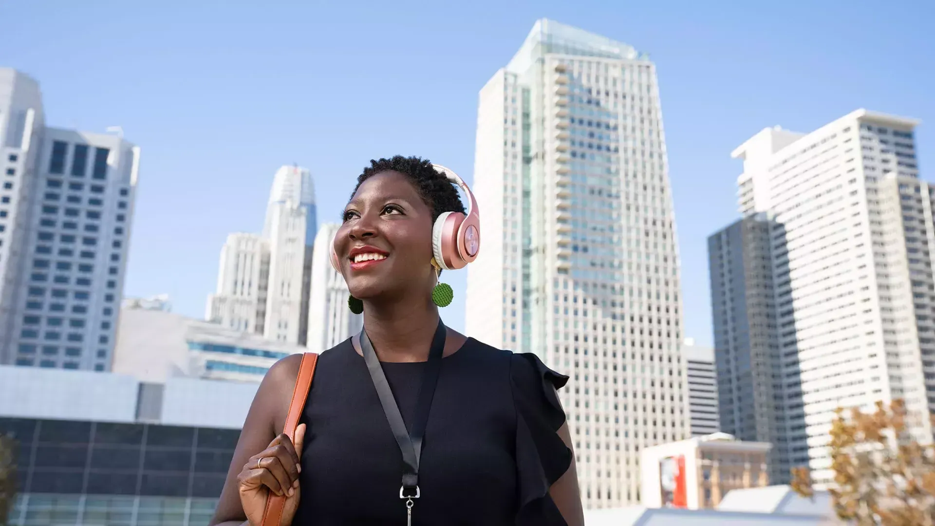 A woman wearing headphones walks through San Francisco's SoMa neighborhood.