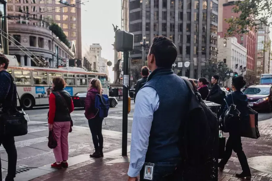 Back of Nick Whittlesey walking in the Financial District.