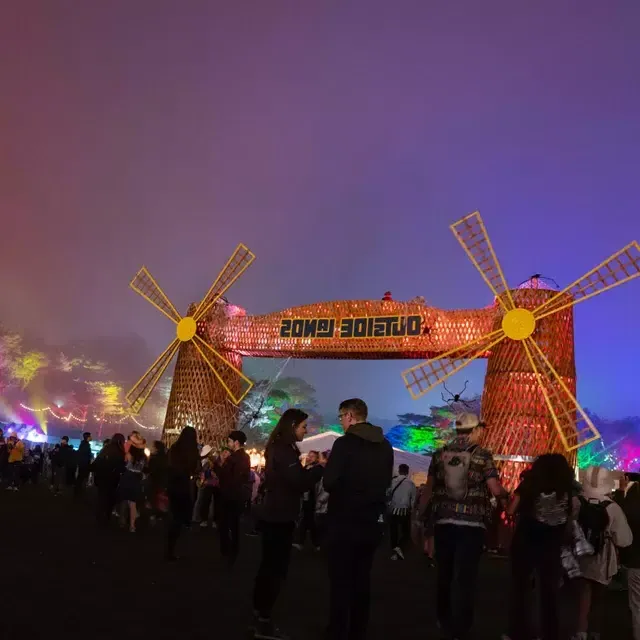 A crowd of festival-goers are pictured at night amid neon lights at the Outside Lands music festival in San Francisco.