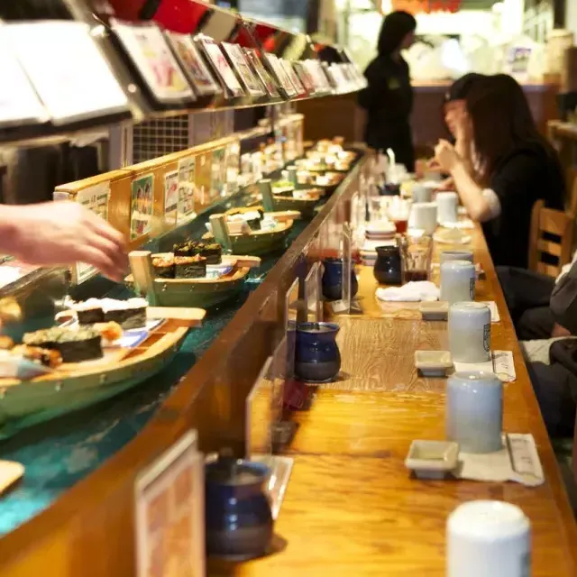 Image of sushi going by on mini-boats